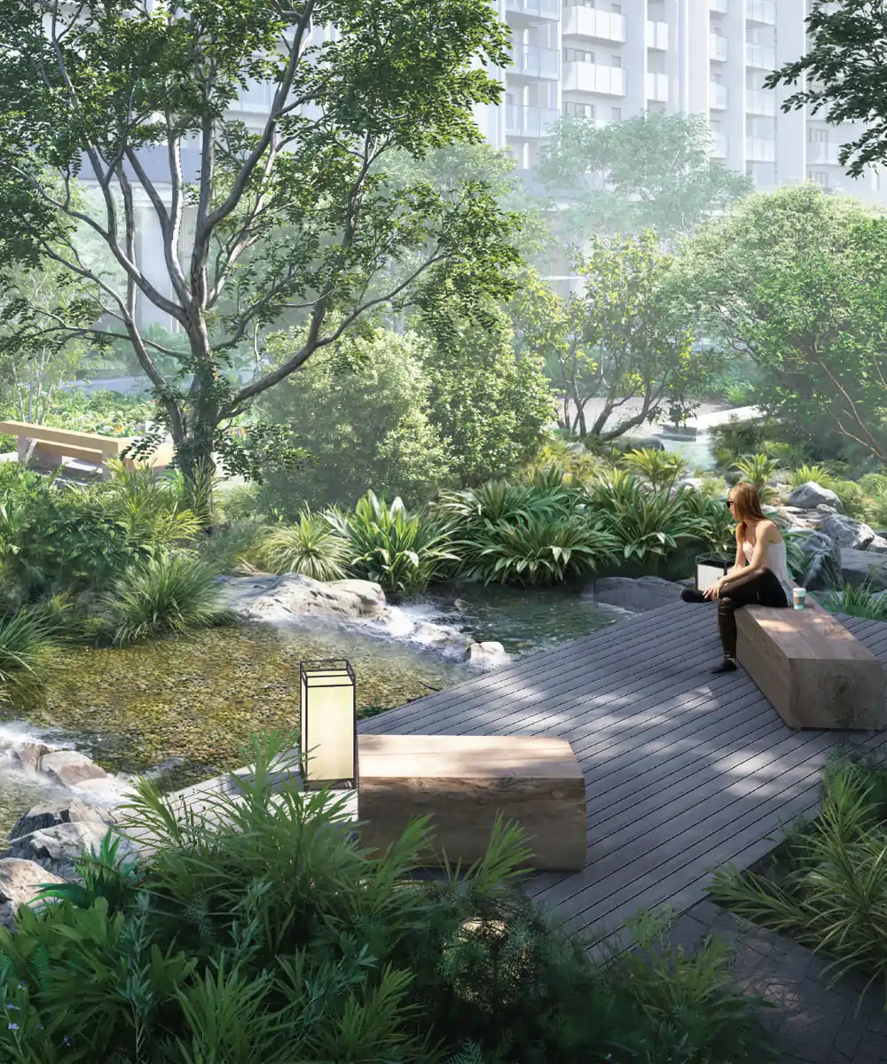 A tranquil yoga deck at Krisumi Waterside Residences The Forest Reserve, featuring natural wood seating, ambient Japanese lanterns, and a serene flowing stream amidst lush forest-inspired landscaping in Sector 36A, Gurugram.